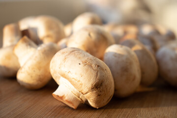 Fresh healthy brown mushrooms with very shallow depth of field. Mushrooms and champignons on the table. Mushrooms on the table top view