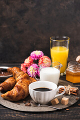 Croissant with chocolate hazelnut spread and cup of coffee