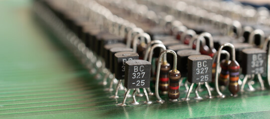 a lot of transistors in the circuit board. arranged in rows. recycling and recovery old electronics