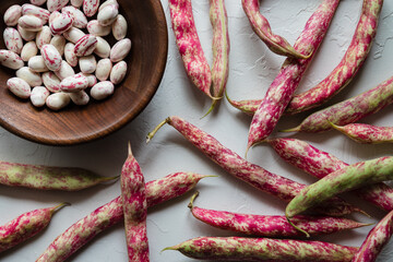 Colorful Cranberry Borlotti Shell Beans Surrounding Shelled Beans in Wooden Bowl