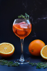 Aperol on a black background with fruits