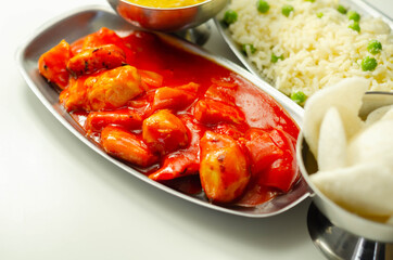 Chinese set,  chicken curry, sweet and sour chicken served with egg fried rice, vegetable spring rolls, and prawn crackers