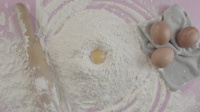 Baking with eggs and flour on rose desk. Baking concept. Top view.