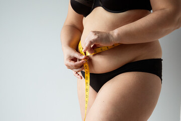 middle aged curvy woman body with belly diet concept