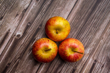 Brazilian apples on wooden table.