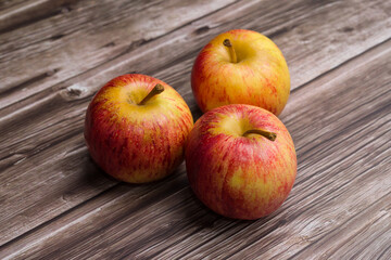 Brazilian apples on wooden table.