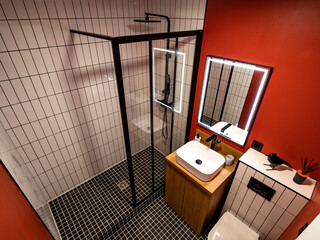 The minimalistic interior of the combined bathroom. Shower and toilet. Saving space.