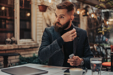 Businessman putting airpods in his ears