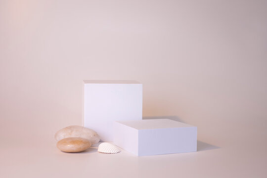 White podium on the white background. Podium for product, cosmetic presentation. Creative mock up. Pedestal or platform for beauty products.