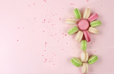 Fresh colorful macaroons on a light table with crumbs, top view, place for text. Modern bakery...