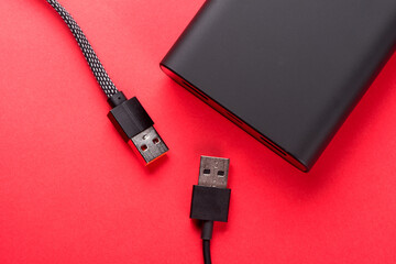 Black Power Bank with adapter for charging mobile devices. Power Bank close-up.