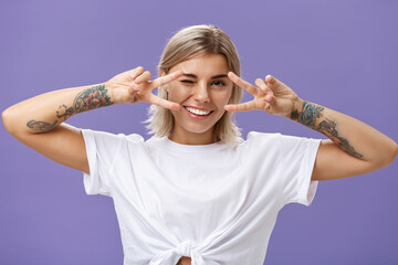 Say cheeze. Portrait of joyful sociable and popular good-looking stylish woman with cool tattoos on...