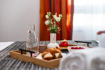 Breakfast in bed. Raspberries, coffee, cake, croissant. Cozy hotel.
