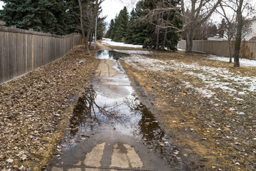 Sidewalk spring melted snow water flood sunken concrete sidewalk