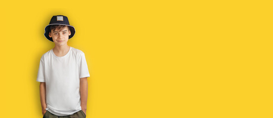 Portrait of boy isolated on yellow background. teenager in casual style outfit. Back to school web banner