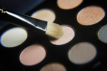 Set of eyeshadow pastel shades and makeup brush. selective focus, shallow depth of field