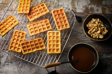 French waffles on a wire rack. Fresh hot corrugated waffles.