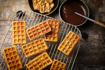 French waffles on a wire rack. Fresh hot corrugated waffles.
