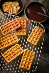 French waffles on a wire rack. Fresh hot corrugated waffles.