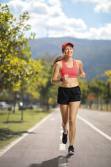 Young woman jogging in the city on a summer day