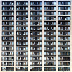 Fototapeta na wymiar Facade of an apartment block house with glass balconies square format front perspective