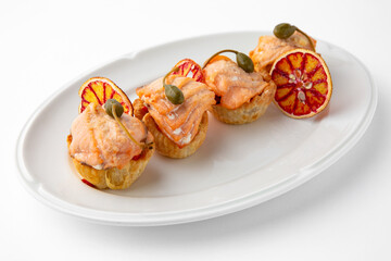 Large pieces of fillet baked with salmon cheese and sauce. Banquet festive dishes. Gourmet restaurant menu. White background.