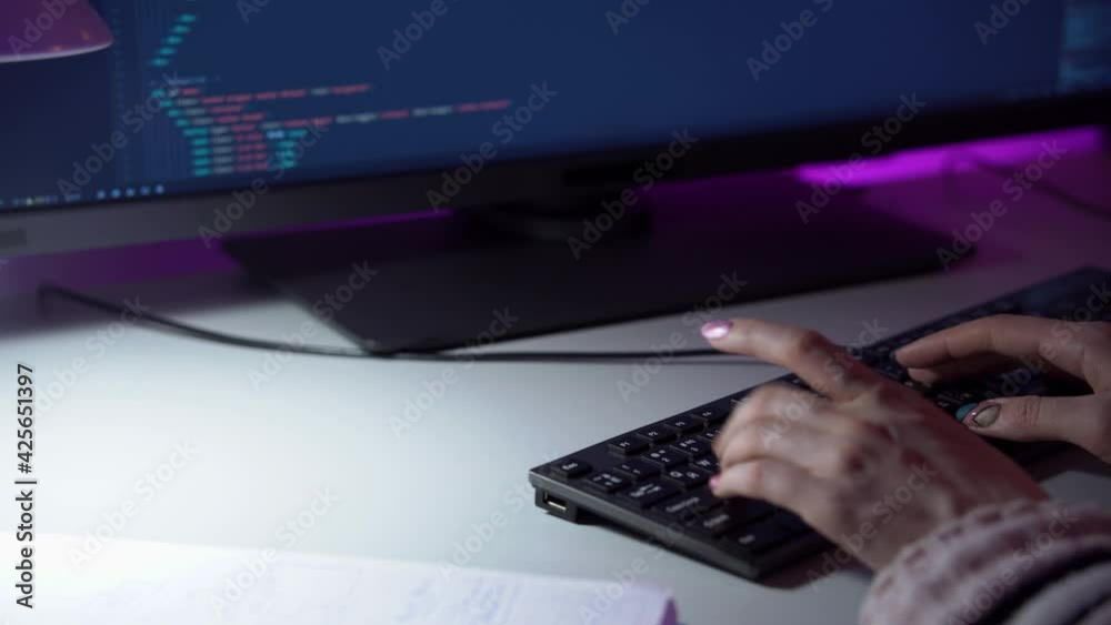 Wall mural macro footage of female programmer who is writing new lines of html code by typing on keyboard. a wo