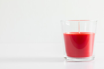 Red candle in transparent glass on white background, mock up