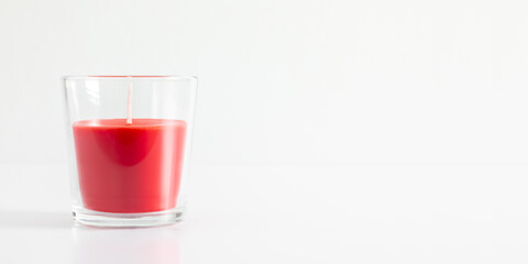 Red candle in transparent glass on white background, mock up