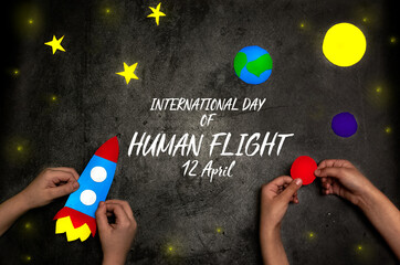 International day of human space flight. Hands of boy and girl holding space rocket against the background of space and planets with stars. 12 April World Cosmonautics Day