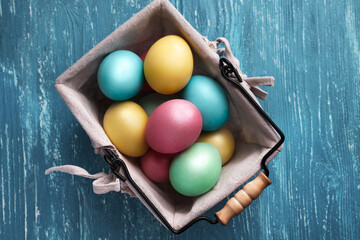 Multicolored painted eggs for easter with pussy willow sprig on wooden background