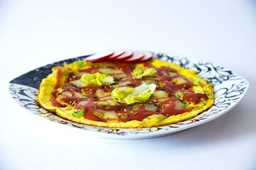 Juicy pizza omelet with ham and spring onions, spices, lettuce, radishes, topped with tomatoes and melted cheese