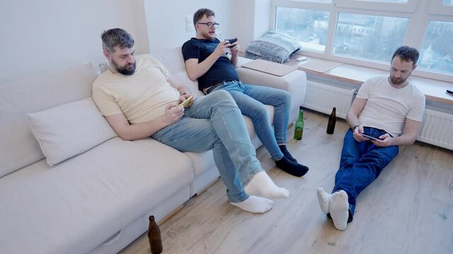 A modern home meeting where everyone is looking at their phones. Youth communication problems and smartphone addiction nomophobia