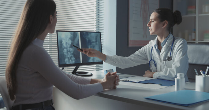 Doctor checking a patient's x-ray of spine