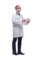 Side view of confident doctor wearing uniform and glasses using digital tablet