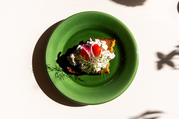 Vegan Skagen Toast served on a plate with tomatoes, red onion, dill