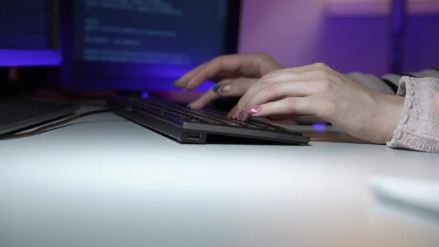 Woman is typing new html lines and her male colleague sits next to her writing schema in macro. Two programmers are talking in process of developing new software. Team work concept. Web design theme