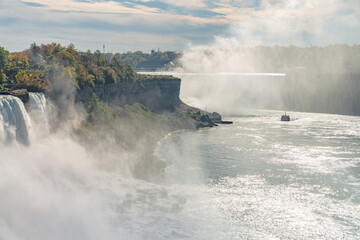 Tour boat silhouette between Horseshoe Falls and American Falls on Niagara river