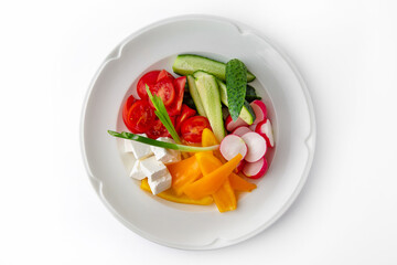 Snack from fresh vegetables and cheese. Tomatoes, cucumbers, peppers, onions. Banquet festive dishes. Gourmet restaurant menu. White background.
