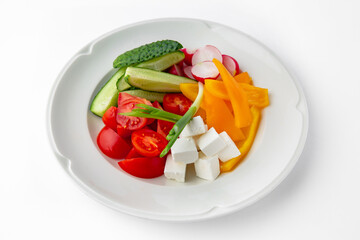 Snack from fresh vegetables and cheese. Tomatoes, cucumbers, peppers, onions. Banquet festive dishes. Gourmet restaurant menu. White background.