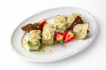Cake portions of salmon and spinach. Delicate roll stuffed with fish, vegetables and herbs. Banquet festive dishes. Gourmet restaurant menu. White background.