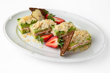 Cake portions of salmon and spinach. Delicate roll stuffed with fish, vegetables and herbs. Banquet festive dishes. Gourmet restaurant menu. White background.