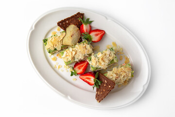 Cake portions of salmon and spinach. Delicate roll stuffed with fish, vegetables and herbs. Banquet festive dishes. Gourmet restaurant menu. White background.
