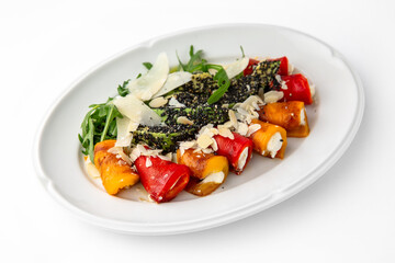 Appetizer of grilled sweet peppers. Rolls stuffed with cheese. Banquet festive dishes. Gourmet restaurant menu. White background.