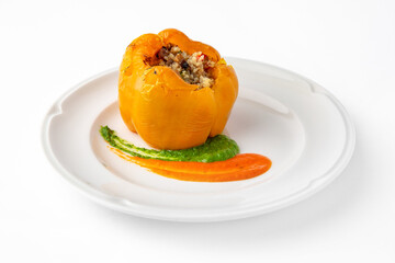 Sweet peppers stuffed with rice, vegetables and meat, baked in the oven. Banquet festive dishes. Gourmet restaurant menu. White background. 