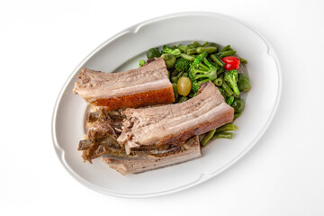 Large pieces of pork baked in spices. Banquet festive dishes. Gourmet restaurant menu. White background.