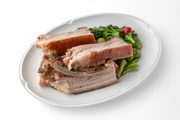 Large pieces of pork baked in spices. Banquet festive dishes. Gourmet restaurant menu. White background.