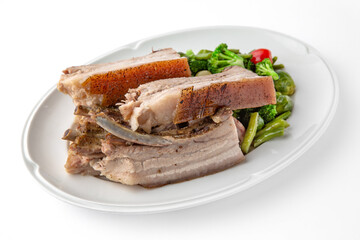 Large pieces of pork baked in spices. Banquet festive dishes. Gourmet restaurant menu. White background.
