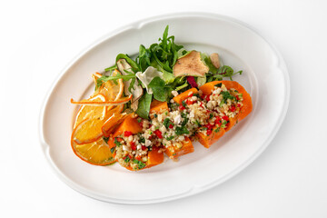 Vegetarian dish, baked carrots baked with bulgur and vegetables. Banquet festive dishes. Gourmet restaurant menu. White background.