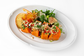 Vegetarian dish, baked carrots baked with bulgur and vegetables. Banquet festive dishes. Gourmet restaurant menu. White background.